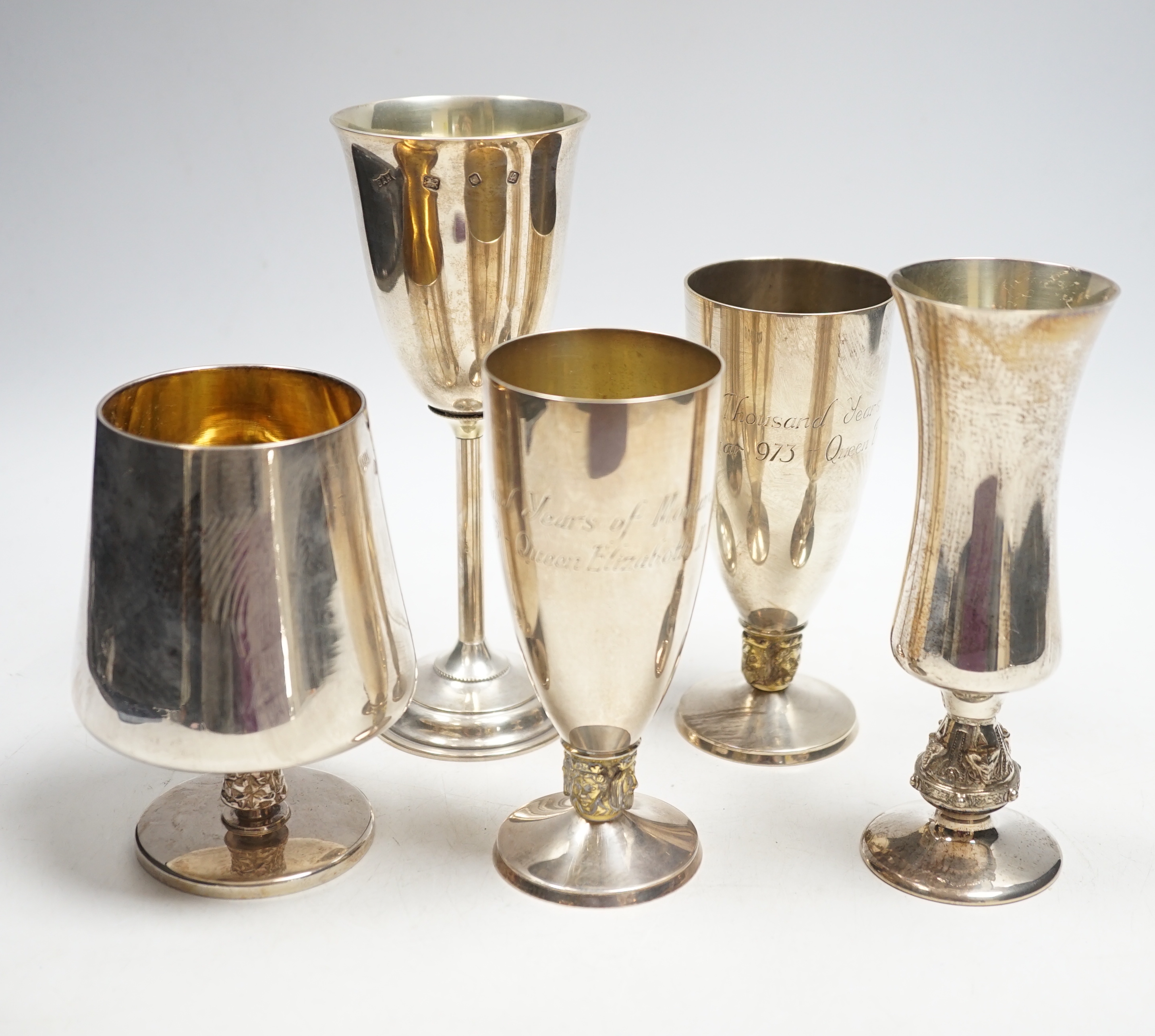 A pair of modern silver commemorative pedestal goblets, '1000 Years of Monarchy', by Mappin & Webb, London, 1973, 13.2cm and three other modern silver goblets, 30.8oz.